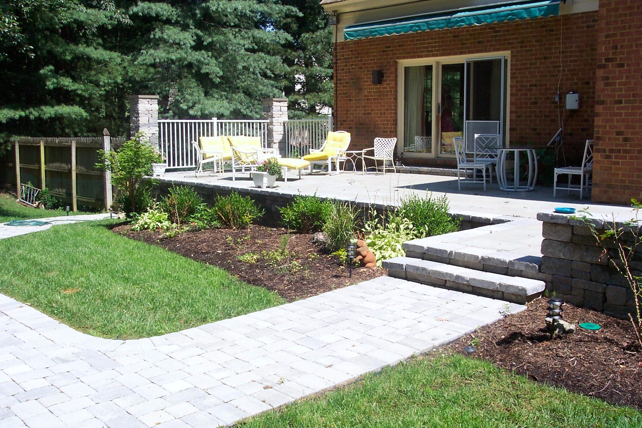 This is a raised patio that transitions down to a walkway with nice ...